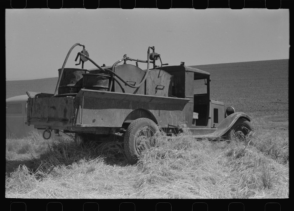 Gasoline, fuel oil and lubricants are carried to tractor and combine in wheat field. Eureka Flats, Walla Walla County…
