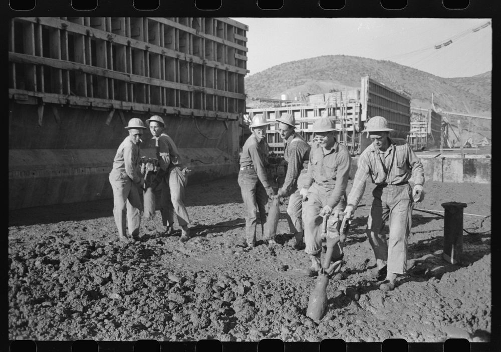 Workmen using viberators which spread the wet concrete in construction of Shasta Dam, Shasta County, California by Russell…