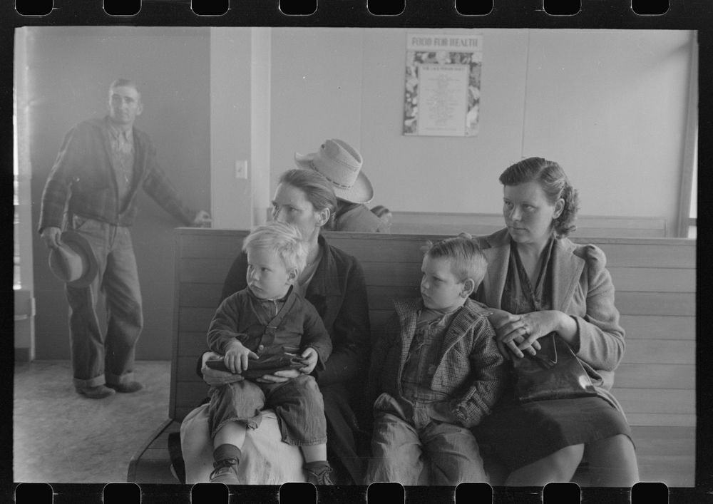 Agricultural workers wait in the clinic at the FSA (Farm Security Administration) farm workers community, Woodville…