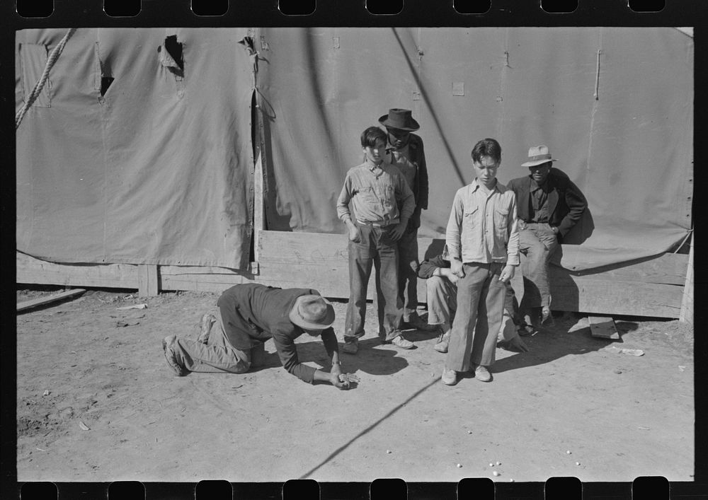 Agricultural workers play marbles. Yuma County, Arizona by Russell Lee