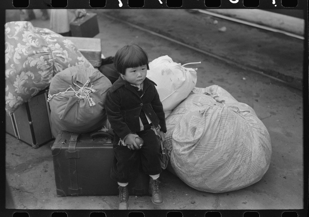 Los Angeles, California. Japanese-American child who is being evacuated with his parents to Owens Valley by Russell Lee