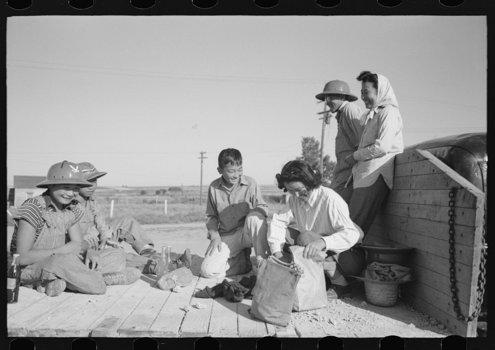 Nyssa, Oregon. FSA (Farm Security Administration) mobile camp. A Japanese-American farm worker's family having lunch by…