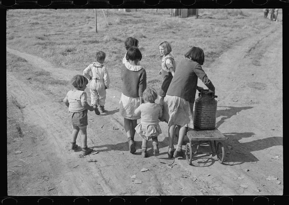 Children of migratory workers, hauling water, American River camp, San Joaquin Valley, California. Sourced from the Library…