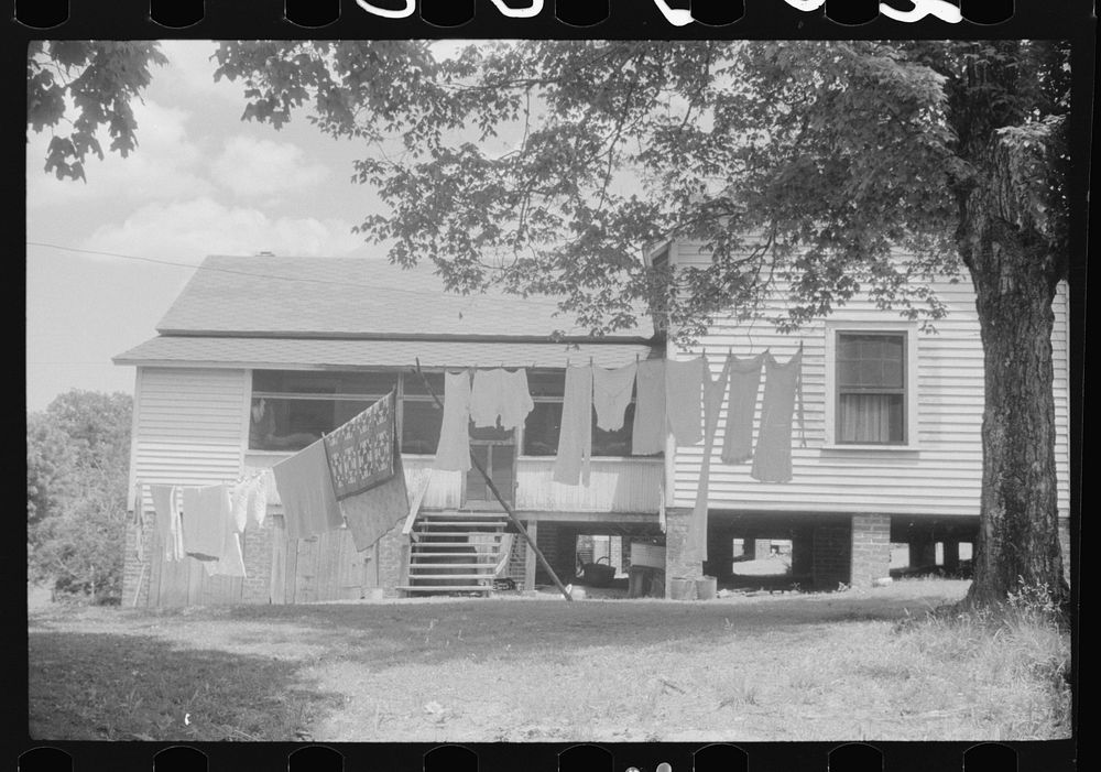 Old company house on wash day. Swepsonville, North Carolina. Sourced from the Library of Congress.