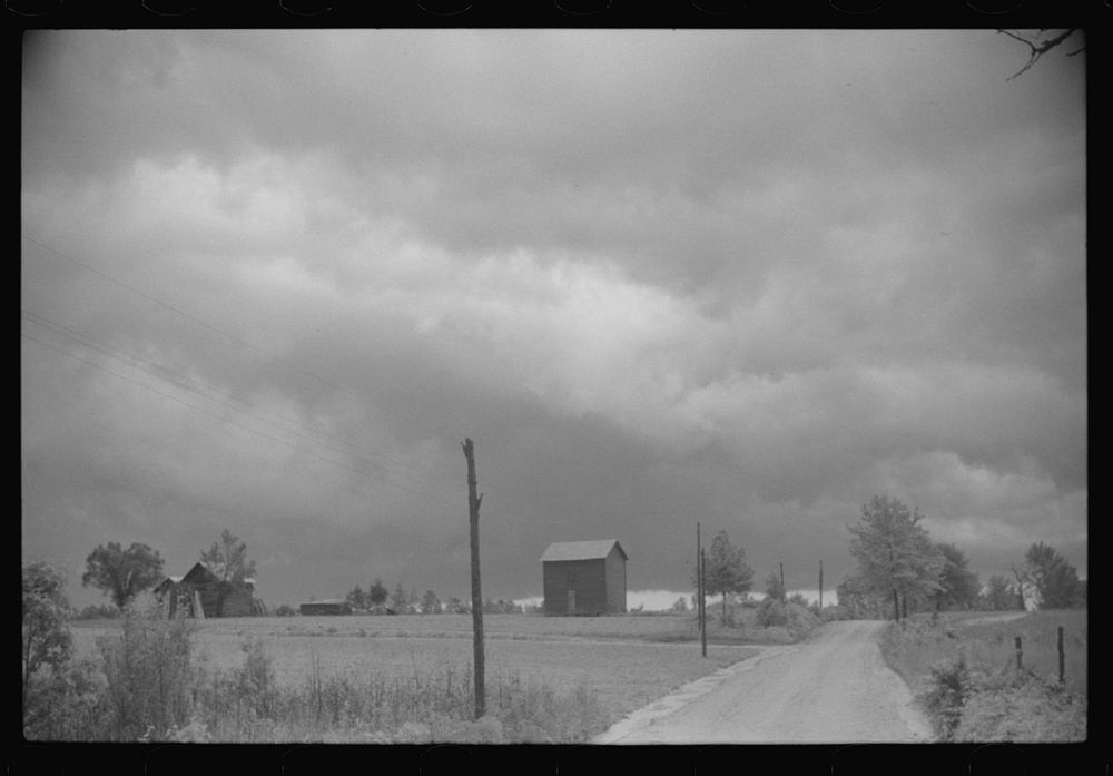 [Untitled photo, possibly related to: Storm brewing. A country road near Stem, North Carolina]. Sourced from the Library of…