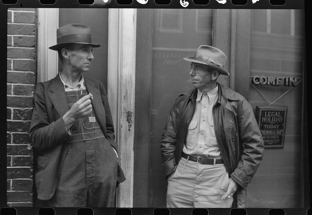 [Untitled photo, possibly related to: Two farmers talking outside of a main street bank, Roxboro, North Carolina, Memorial…