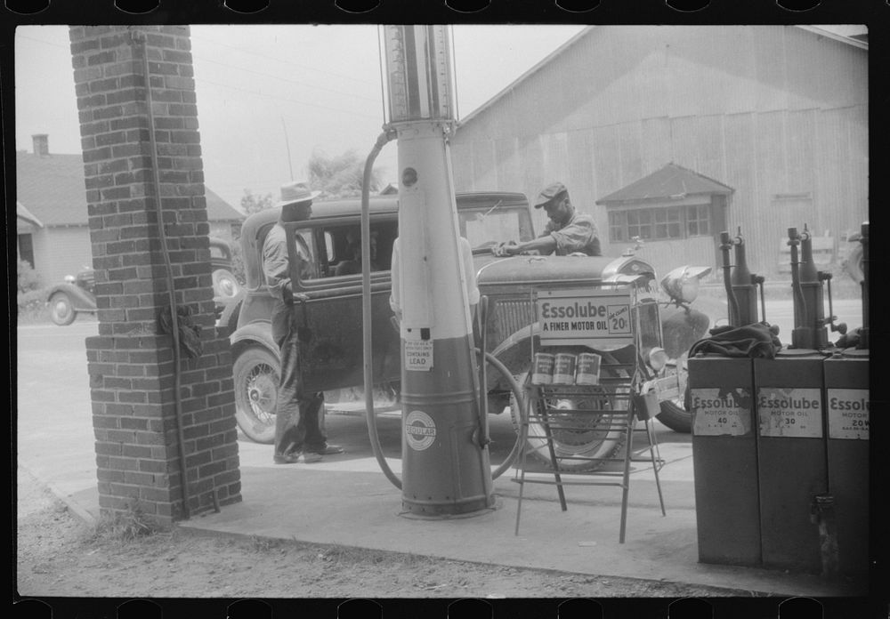 Migratory agricultural workers getting gas at the store in Camden, North Carolina. Sourced from the Library of Congress.