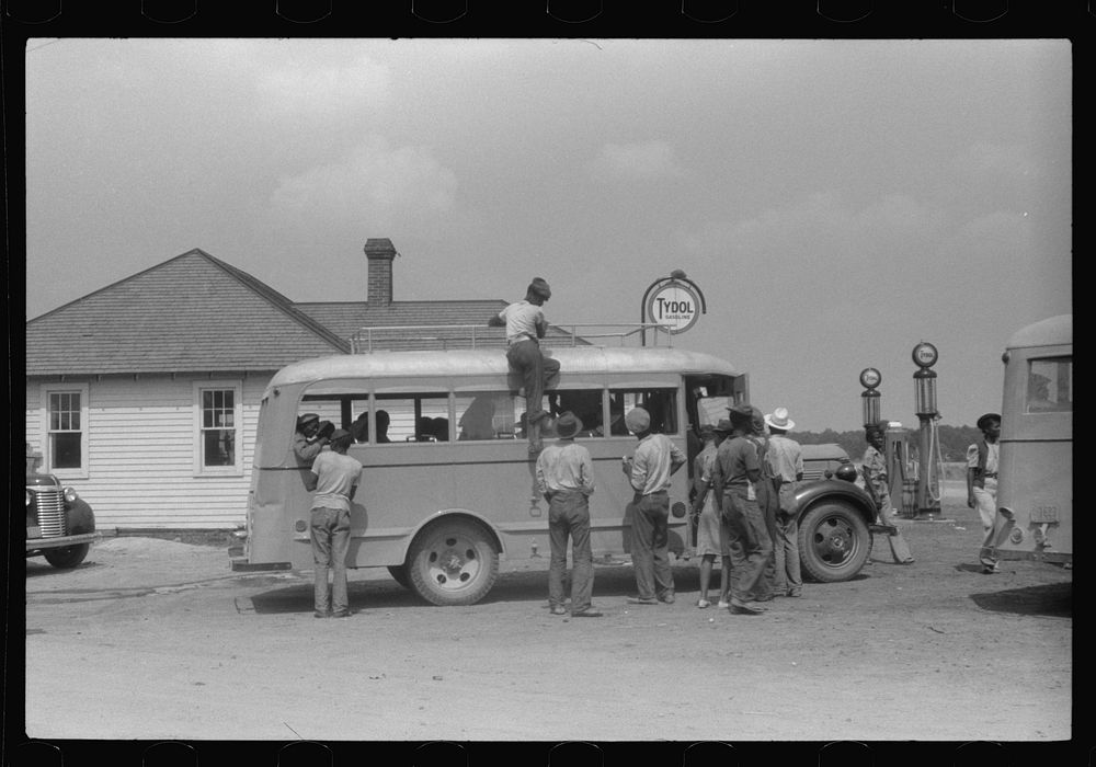 Migratory bean pickers being loaded into school buses for transportation to the bean fields. Statensville, Delaware. Sourced…