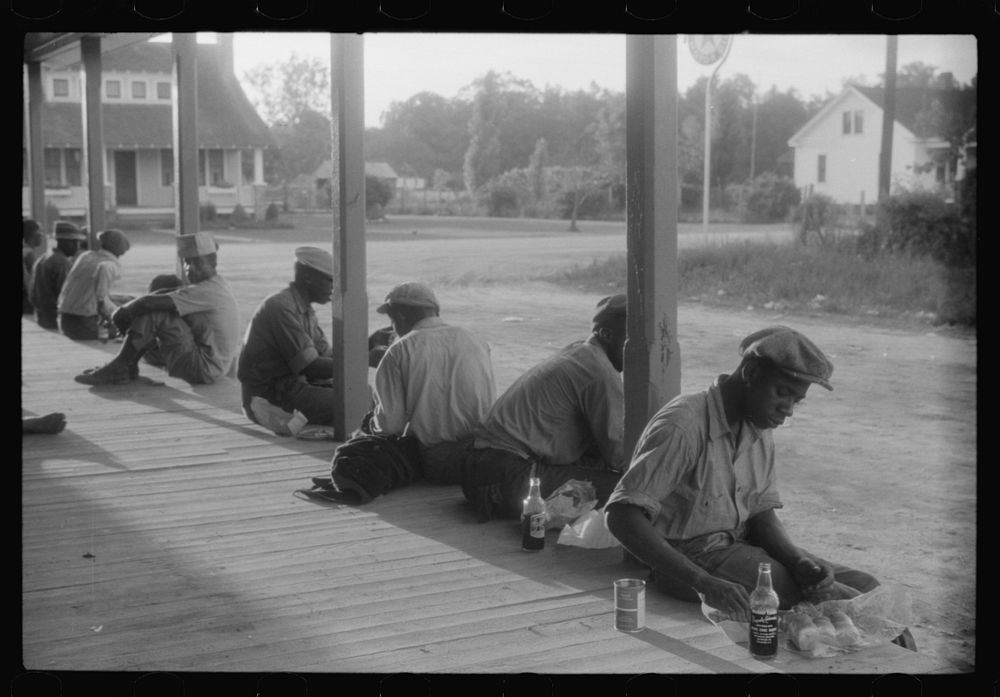 [Untitled photo, possibly related to: Migratory agricultural workers having supper at the store in Belcross, North…