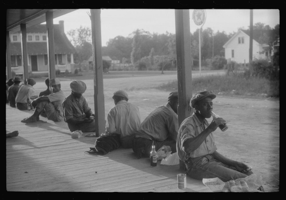 Migratory agricultural workers having supper at the store in Belcross, North Carolina. Sourced from the Library of Congress.