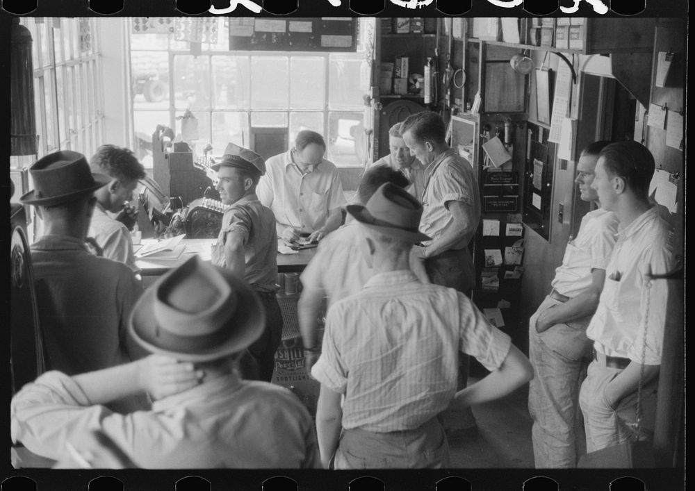 [Untitled photo, possibly related to: Truck driver in front of bulletin board in a truck service station on U.S. 1 (New York…