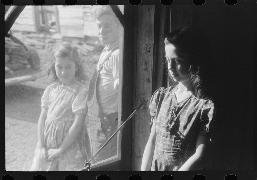 Two of the Dumond children at the back door of their home in Lille, Maine. French-Canadian potato farmers and FSA (Farm…