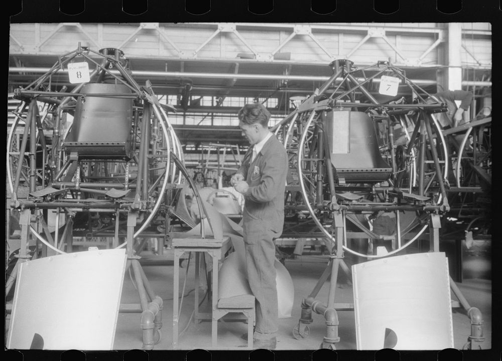 Working on the fuselage assembly at the Vought-Sikorsky Aircraft Corporation, Stratford, Connecticut. Sourced from the…