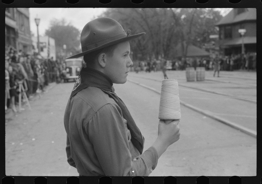 Boy scout hold string at finish line of the annual barrel rolling contest. Presque Isle, Maine. Sourced from the Library of…