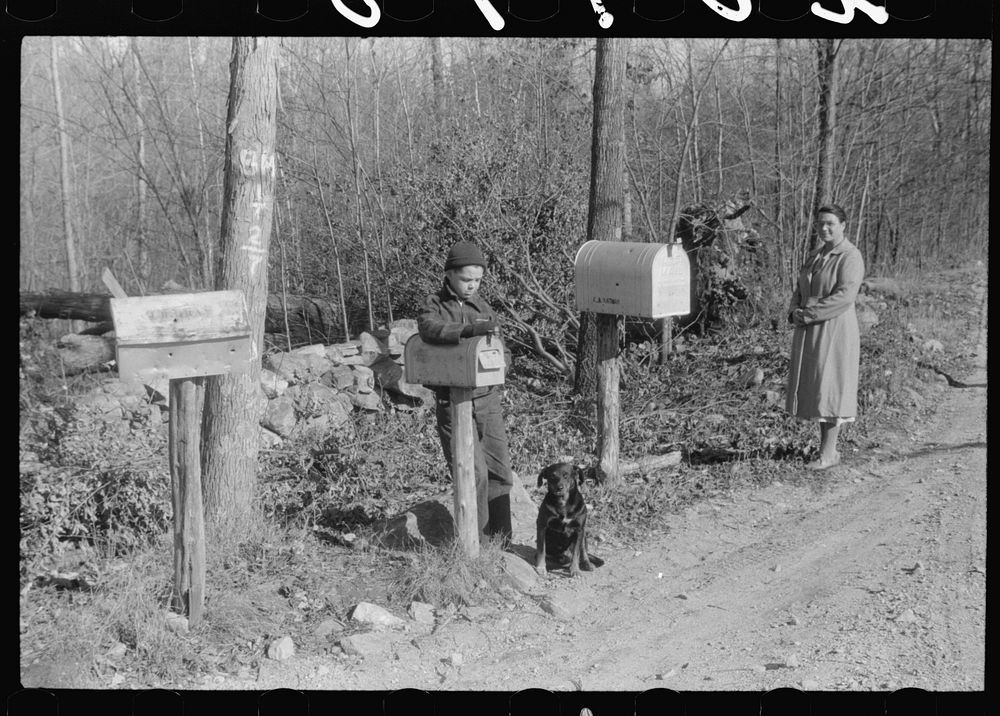 Waiting at a crossroads in Ledyard, Connecticut for the mail carrier. Little boy is a member of the Crouch family. Sourced…