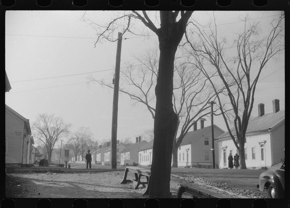 [Untitled photo, possibly related to: A street in Taftville, Connecticut, during the changing of the shift at the textile…