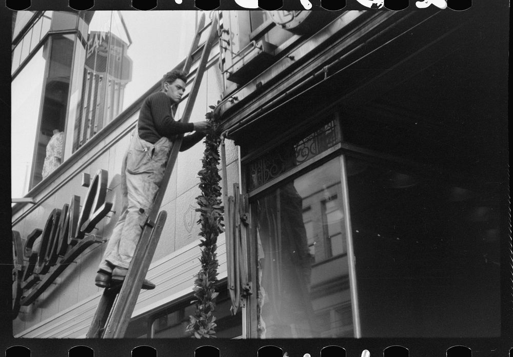 [Untitled photo, possibly related to: Hanging Christmas decorations in Providence, Rhode Island]. Sourced from the Library…