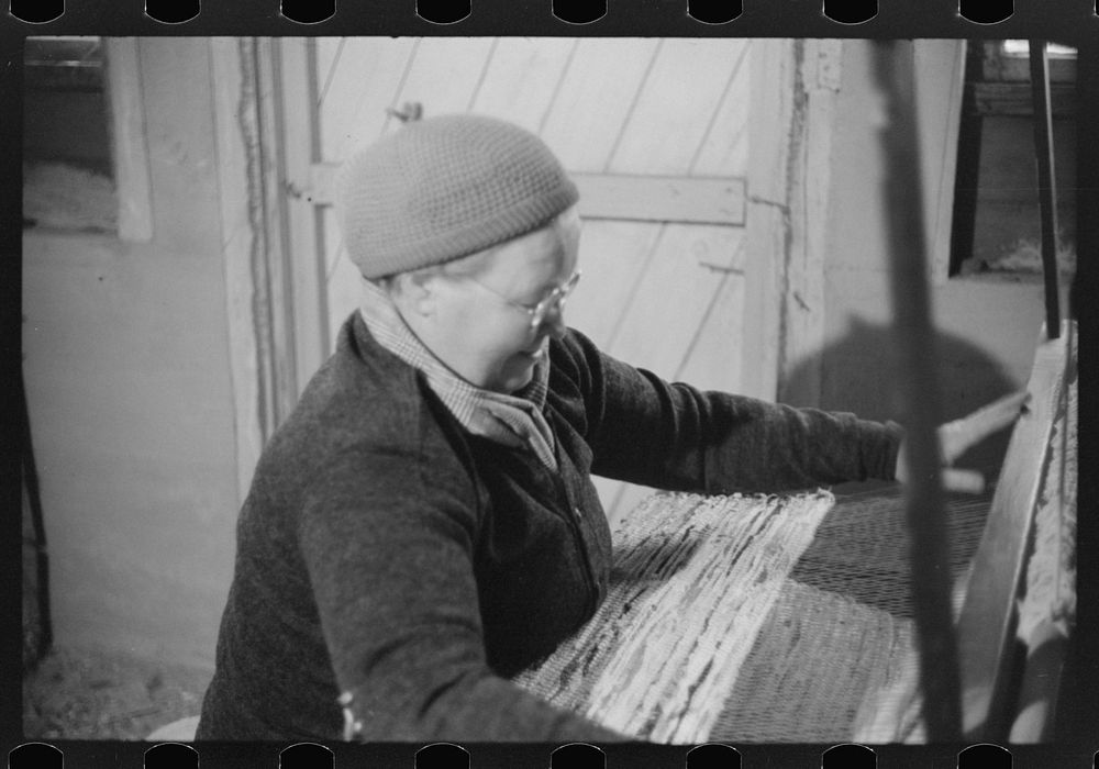 Mrs. Simon Kertulla, working at her old fashioned loom. Finnish poultry farmer. Foster, Rhode Island. Sourced from the…
