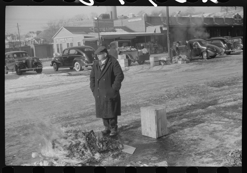 [Untitled photo, possibly related to: Farmer at the Governor Dyer market keeping warm around a fire, Providence, Rhode…