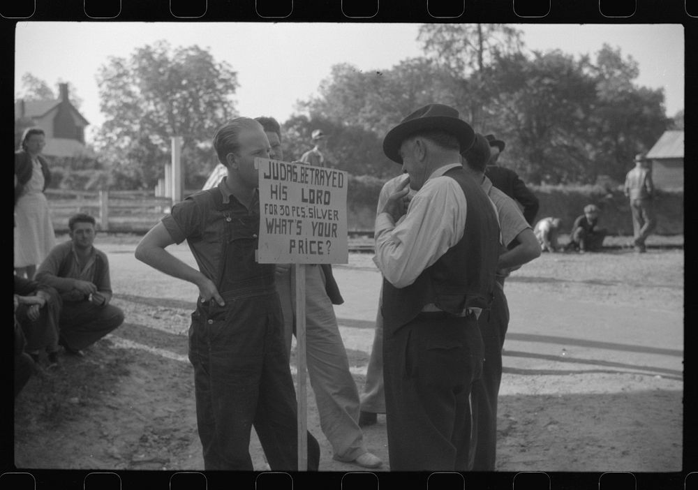 Greensboro chief of police reading CIO picket sign at a textile mill in Greensboro, Greene County, Georgia. Sourced from the…