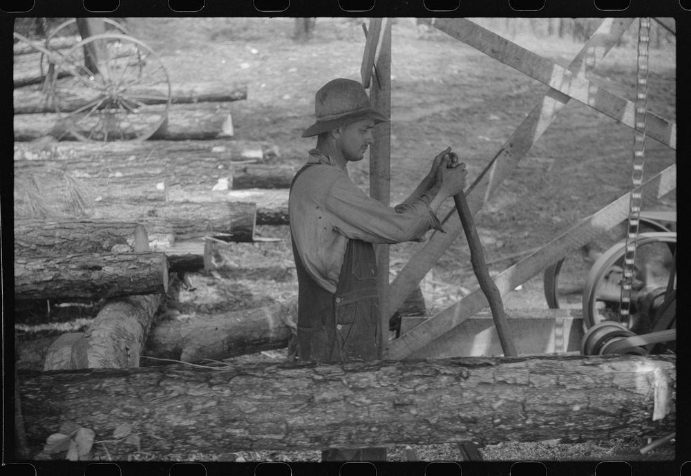 Sawmill worker at a small works in southern Greene County, Georgia. Sourced from the Library of Congress.