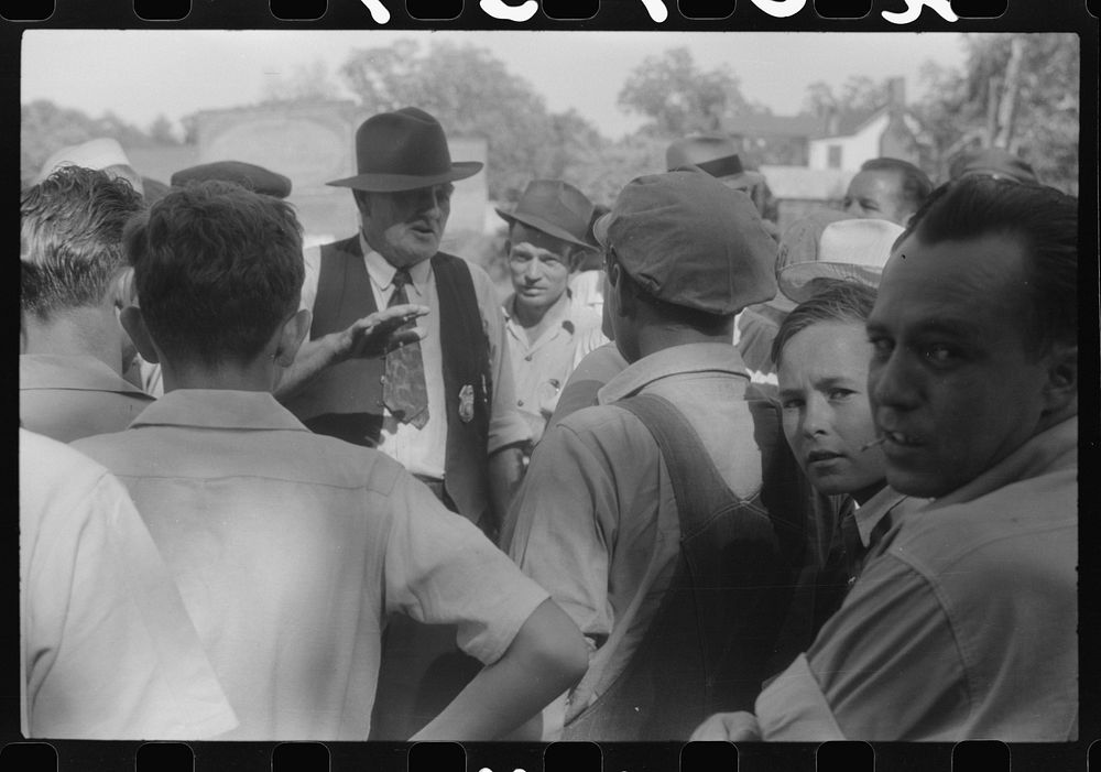Chief of police talking to CIO pickets outside a mill in Greensboro, Greene County, Georgia. Sourced from the Library of…