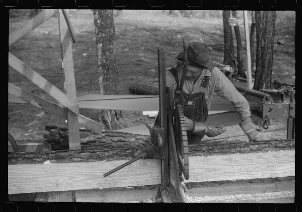 [Untitled photo, possibly related to: A sawmill worker at a small sawmill works in southern Greene County, Georgia]. Sourced…