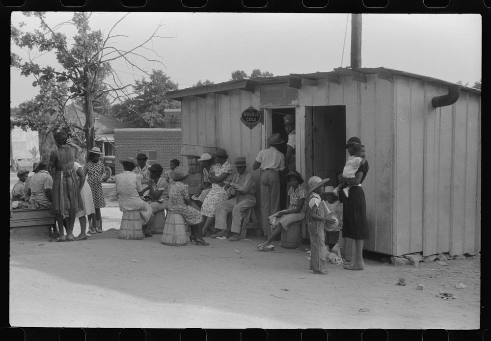 Saturday afternoon outside of a  store and barbershop in Union Point, Greene County, Georgia. Sourced from the Library of…