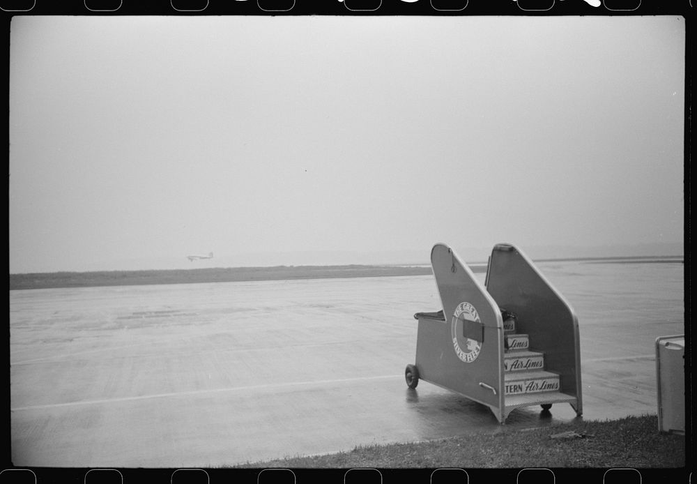 A plane taking off on a rainy day at the municipal airport, in Washington, D.C.. Sourced from the Library of Congress.