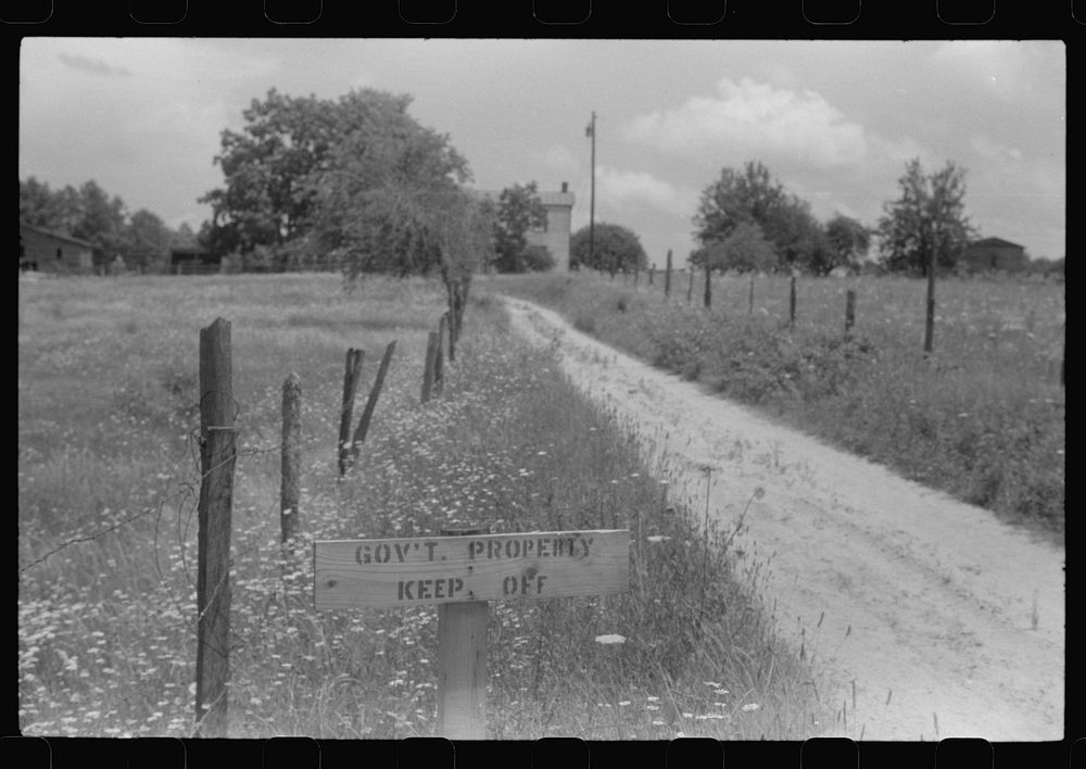 [Untitled photo, possibly related to: Government property sign at an abandoned house in the area taken over by the army for…