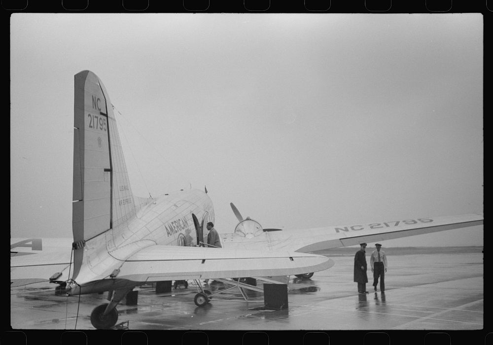 A plane on the field at the municipal airport on a rainy day, Washington, D.C.. Sourced from the Library of Congress.