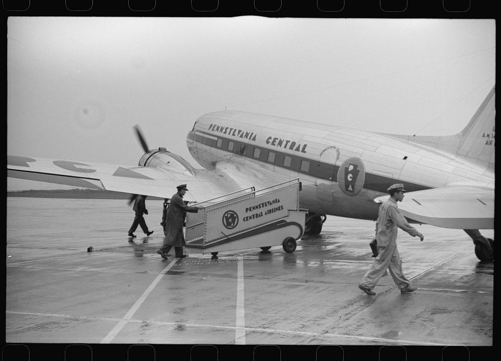 [Untitled photo, possibly related to: Passengers boarding a plane on a rainy day at the municipal airport in Washington…