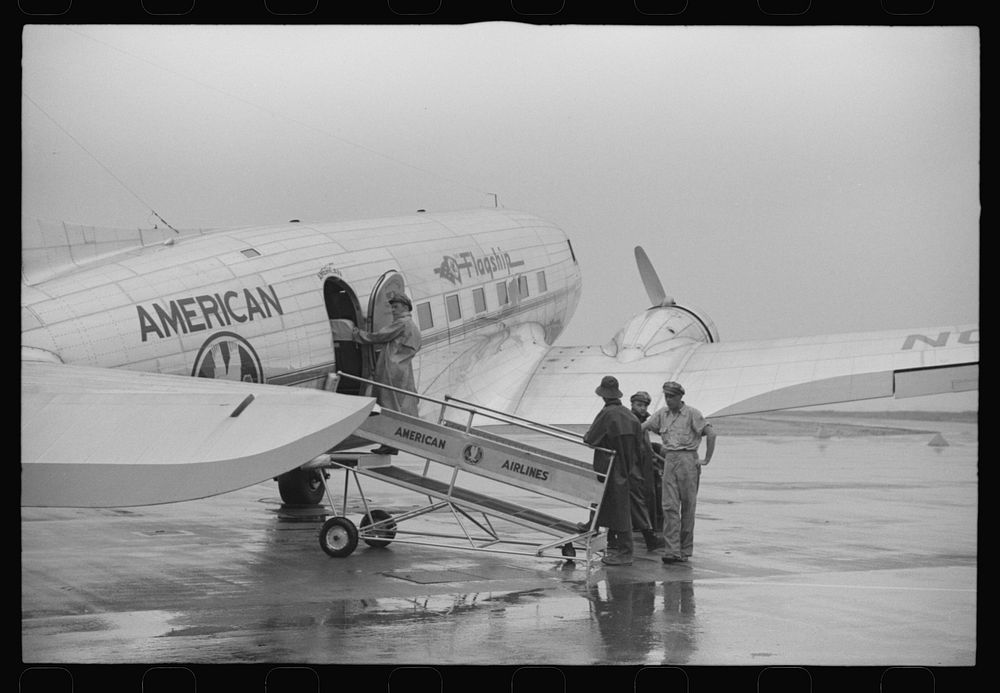 Ground crew getting a plane ready to take off on a rainy day at municipal airport in Washington, D.C.. Sourced from the…