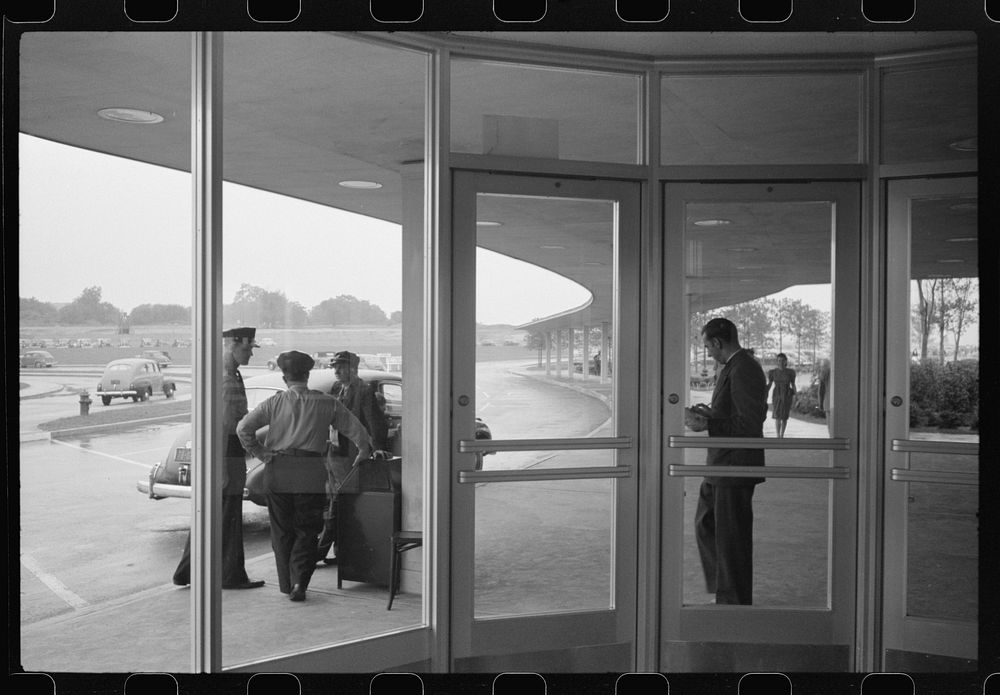 Looking out of one of the vestibules at the entrance to the municipal airport in Washington, D.C.. Sourced from the Library…