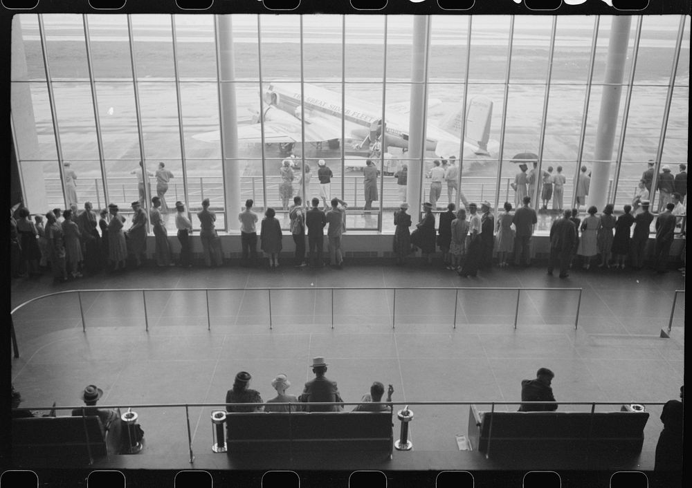 [Untitled photo, possibly related to: Visitors watching planes. Seen from waiting platform at the municipal airport in…