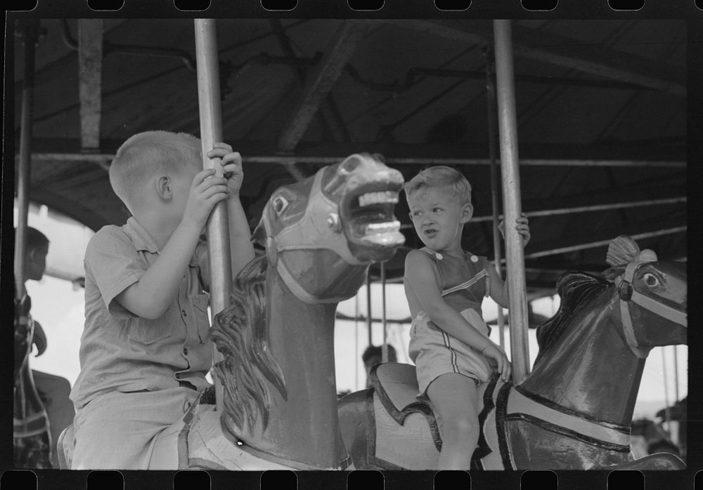 On the merry-go-round of a small American Legion carnival just outside Bellows Falls, Vermont. Sourced from the Library of…