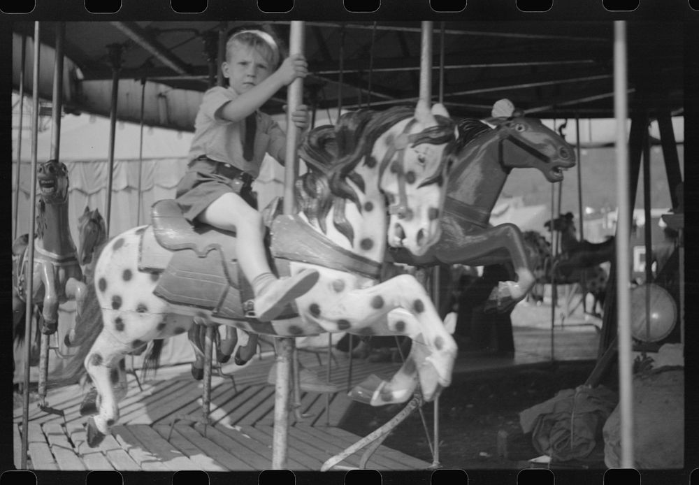[Untitled photo, possibly related to: On the merry-go-round of a small American Legion carnival just outside Bellows Falls…