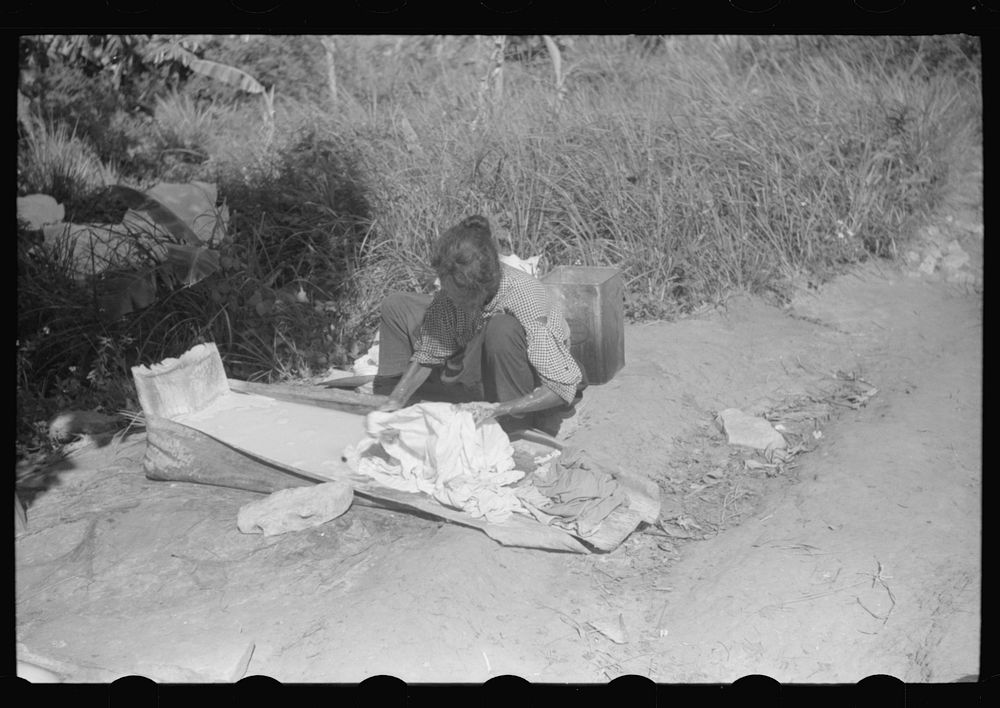 [Untitled photo, possibly related to: Using palm leaf as a wash tub on a farm near Manati, Puerto Rico]. Sourced from the…