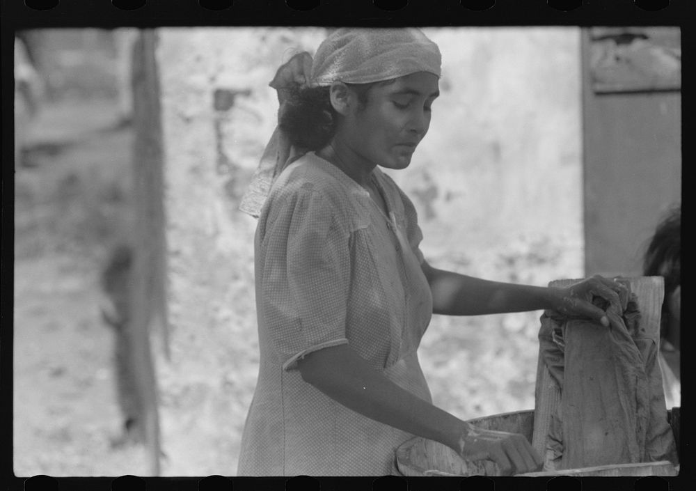 [Untitled photo, possibly related to: Puerto Rican woman washing clothes in one of the slum "villages" near Fredericksted…