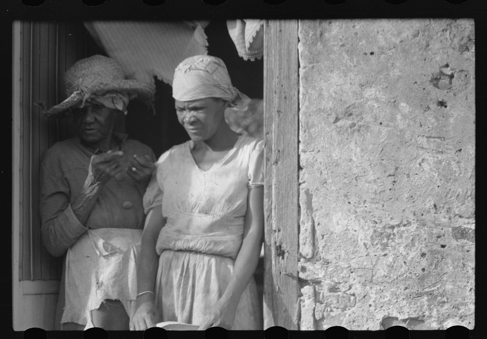 [Untitled photo, possibly related to: Old woman living in one of the slum "villages" in the northwestern part of the island.…