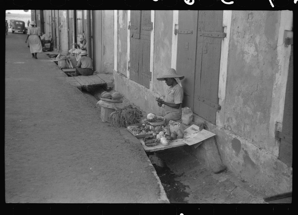 Charlotte Amalie, St. Thomas Island, Virgin Islands. Vegetable vendor along a side street near the waterfront. Sourced from…