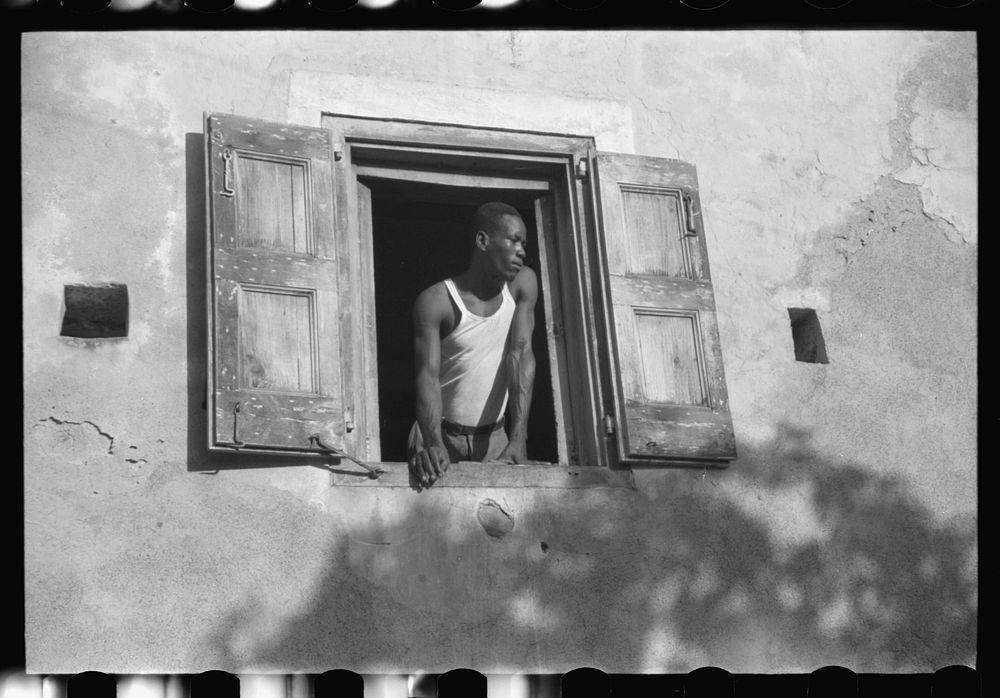 Worker who lives on one of the steep streets in Charlotte Amalie, St. Thomas, Virgin Islands. Sourced from the Library of…