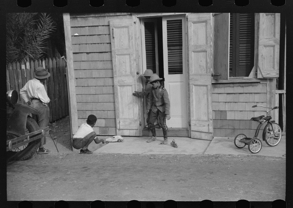 [Untitled photo, possibly related to: Children playing with their Christmas toys on a side street, Charlotte Amalie, St.…