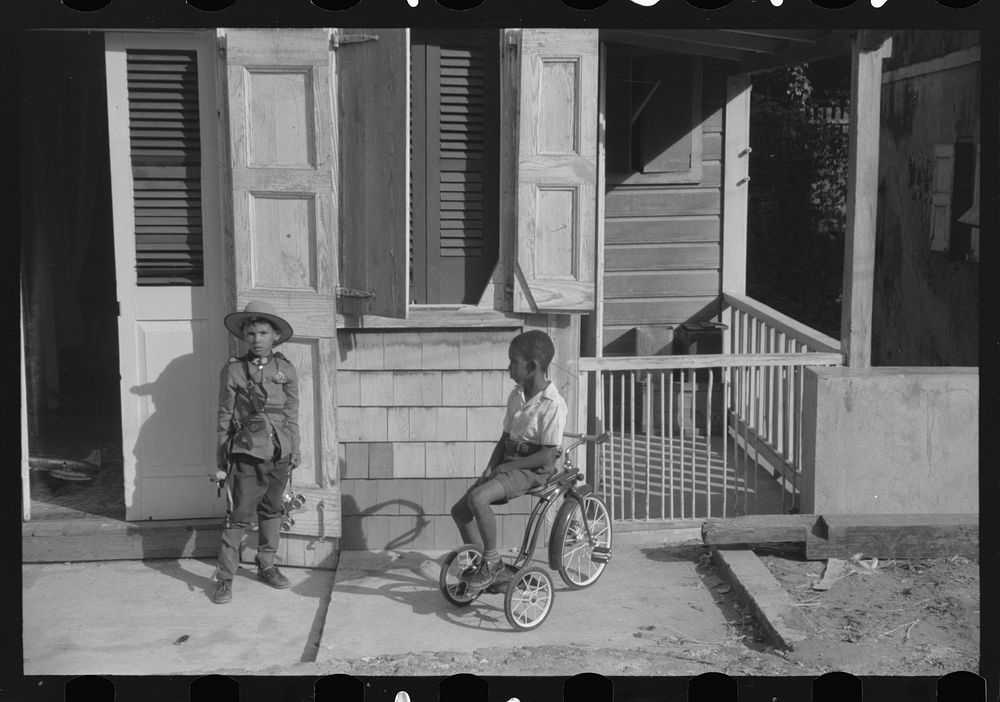 Children playing with their Christmas toys on a side street, Charlotte Amalie, St. Thomas, Virgin Islands. Sourced from the…