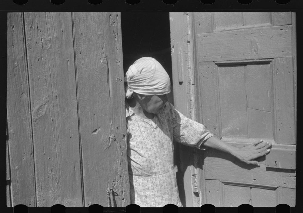 Charlotte Amalie, St. Thomas Island, Virgin Islands. Woman living in one of the bandbox houses. Sourced from the Library of…