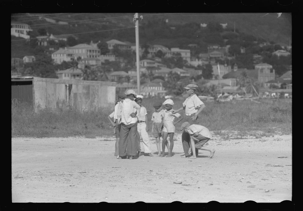 French Village, a small settlement on St. Thomas Island, Virgin Islands. Children playing marbles on an open lot. Sourced…