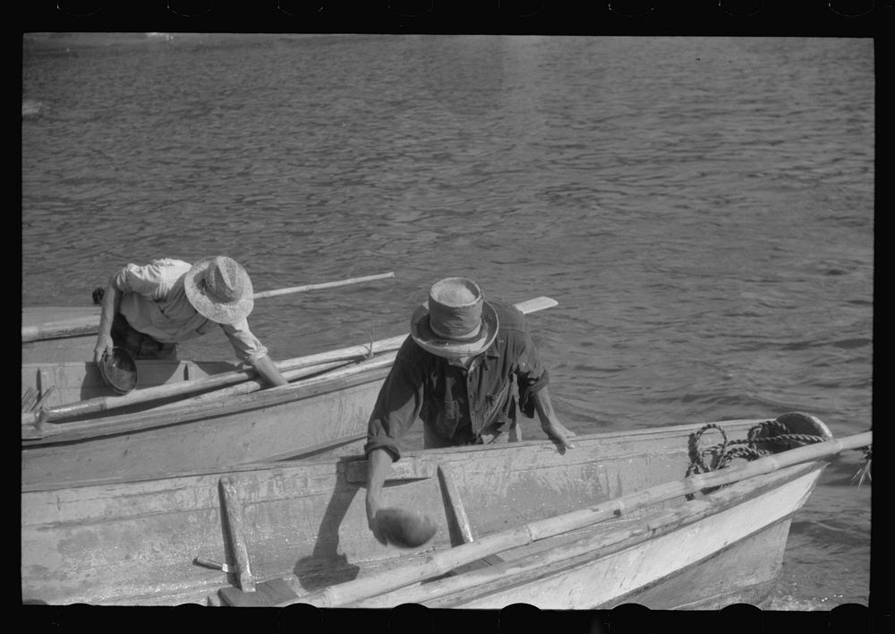 French Village, a small settlement on St. Thomas Island, Virgin Islands. Fishermem bailing their boats after the day's…