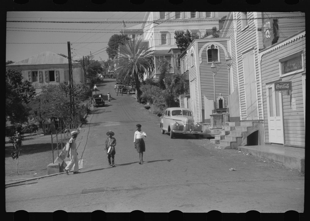 Charlotte Amalie, St. Thomas Island, Virgin Islands. Street scene. The boy in the center is dressed in a Christmas gift…