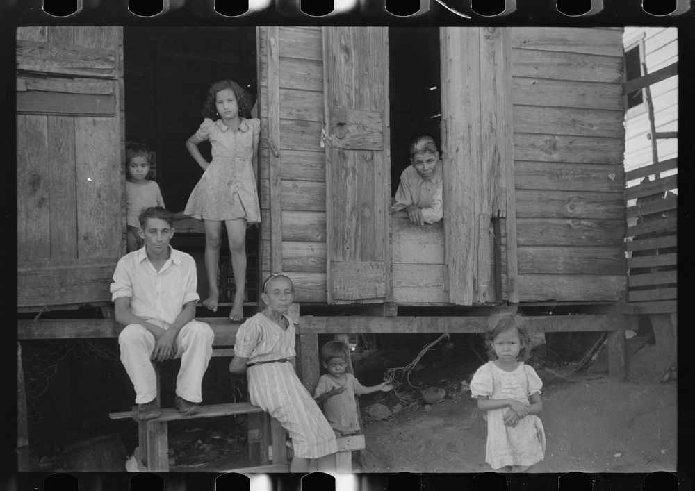 Family living in a slum area in Yauco, Puerto Rico. Sourced from the Library of Congress.
