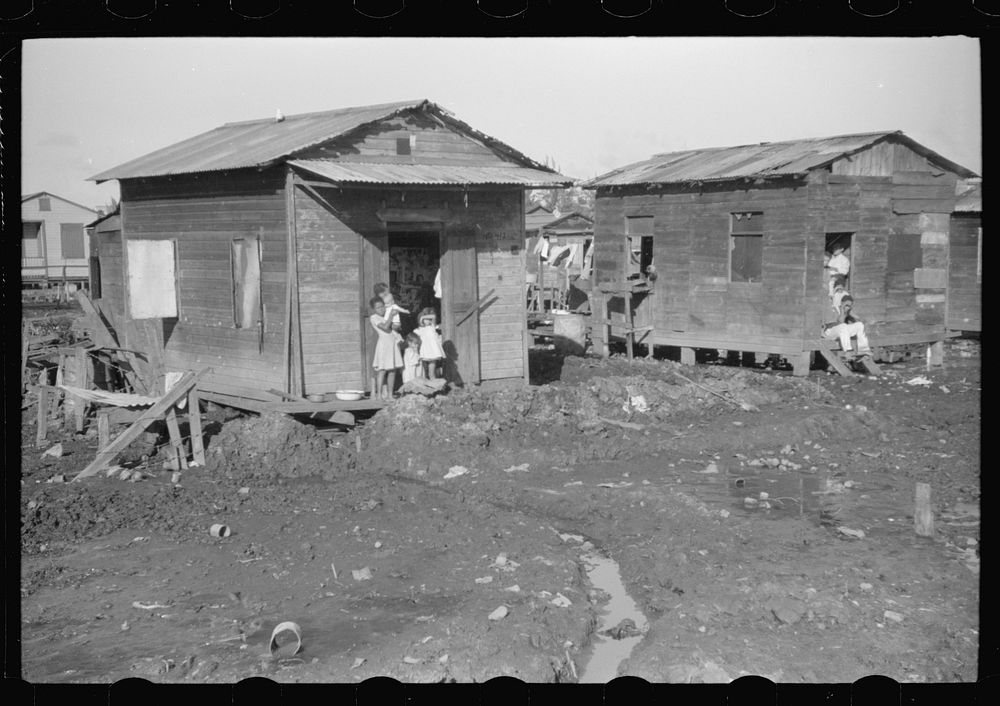 [Untitled photo, possibly related to: Houses in the slum area known as "El Fangitto" (The Mud) in San Juan, Puerto Rico].…